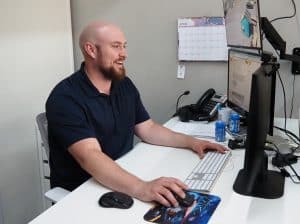 General Manager for Glassical Designs working at his computer