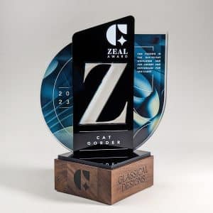 Glassical Designs' "Glassies" award featuring clear and black acrylic mounted on a black walnut wooden base, recognizing employee achievements.